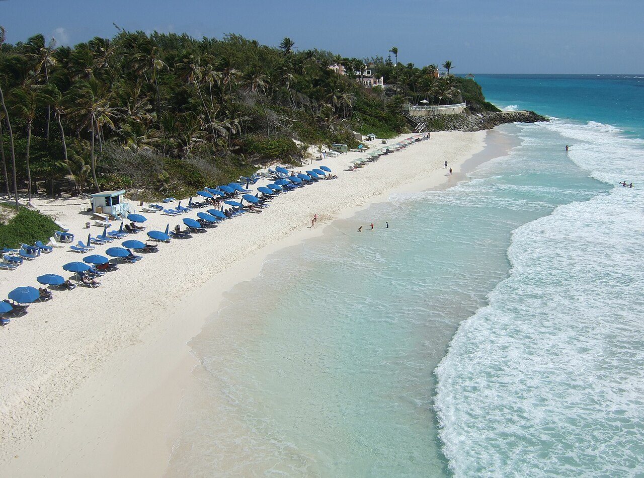 Crane Beach from the coral cliffs above, with pink-tinged sand and Atlantic surf rolling in