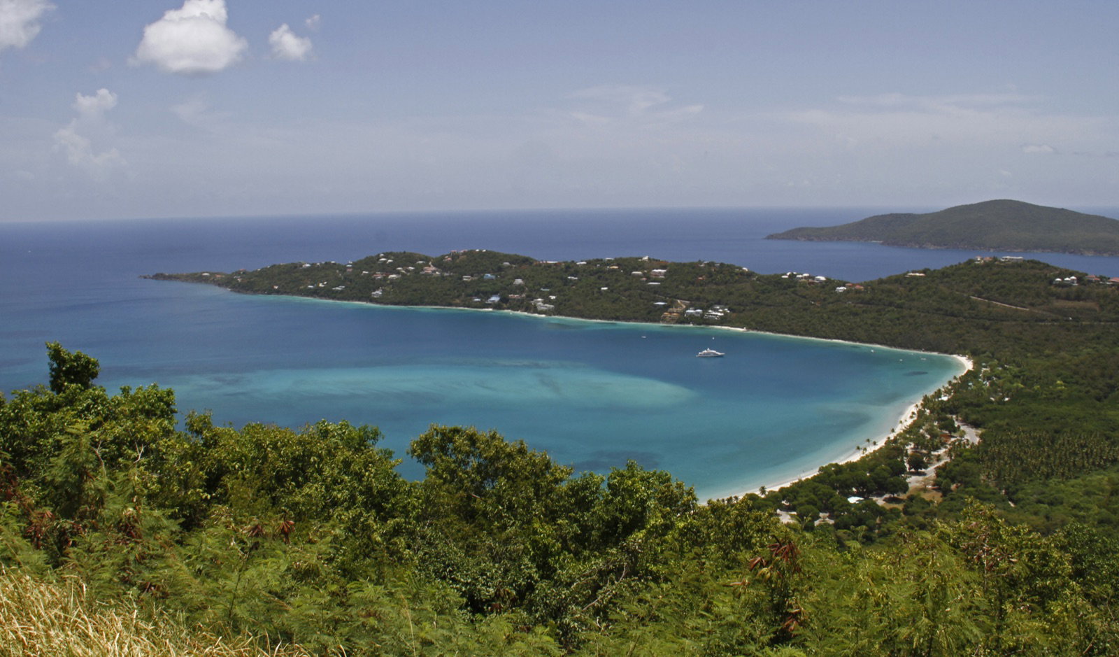 The heart-shaped sweep of Magens Bay from the overlook, white sand curving around turquoise water